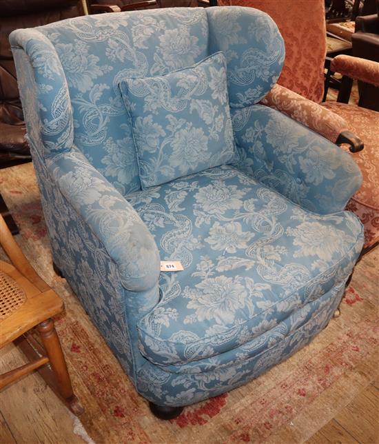 An early 20th century upholstered wingback armchair